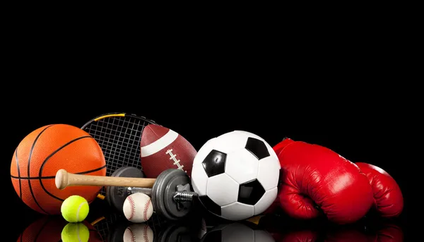 Assorted sports equipment on black — Stock Photo, Image