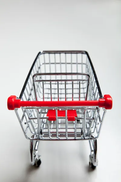 Red supermarket shopping cart on white — Stock Photo, Image