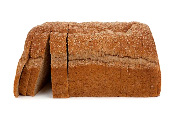 A loaf of sliced wheat bread on white — Stock Photo, Image