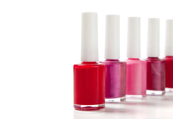 Assorted fingernail polish on a white background with copy space — Stock Photo, Image