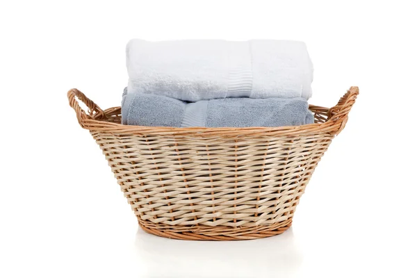 White and blue towels in a laundry basket on white — Stock Photo, Image