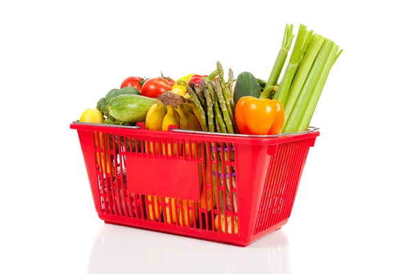 A red shopping basket with vegetables Royalty Free Stock Photos