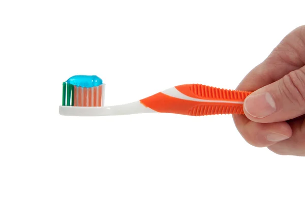 Hand holding an Orange toothbrush on a white background — Stock Photo, Image