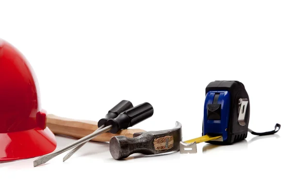 Hardhat with various tools on a white background — Stock Photo, Image