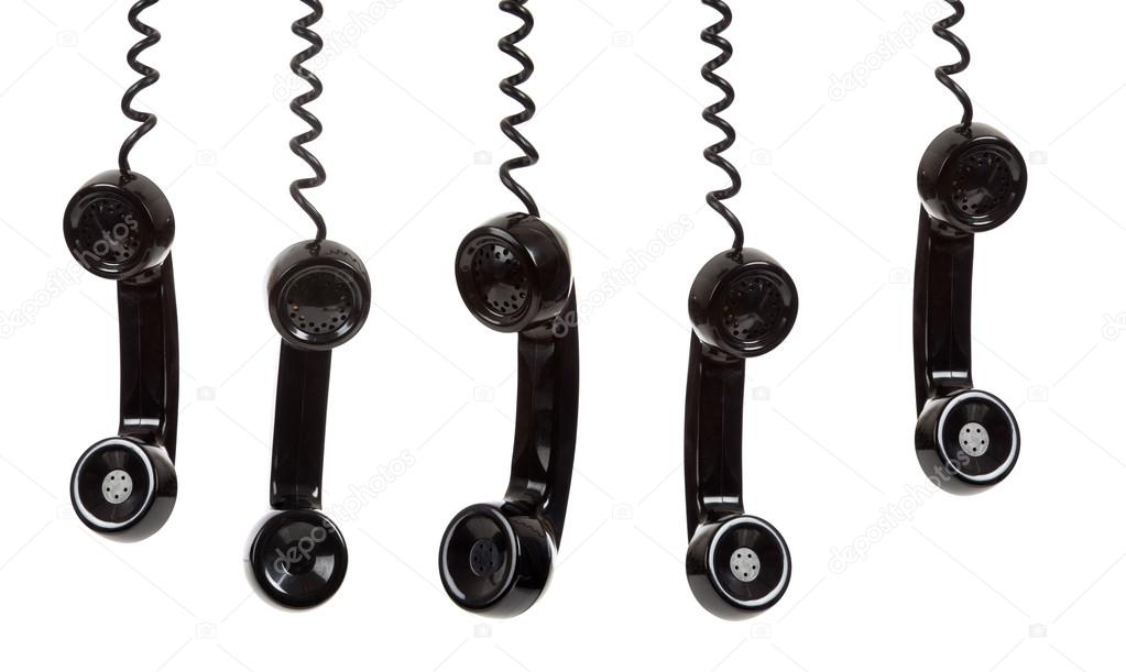 A black telephone receiver on a white background