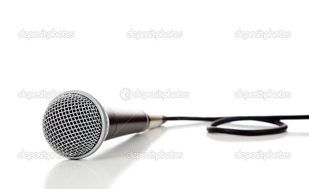 Black and silver microphone on a white background with copy spac