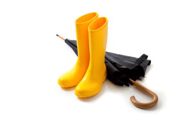 Yellow rainboots and black umbrella on white clipart