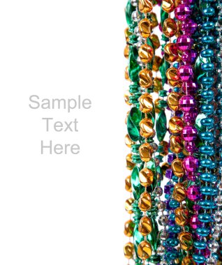 Mardi gras beads on white with copy space