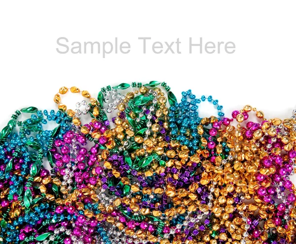 Mardi gras beads on white with copy space — Stok fotoğraf