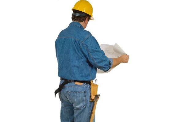Homem da Construção a rever os planos de construção — Fotografia de Stock