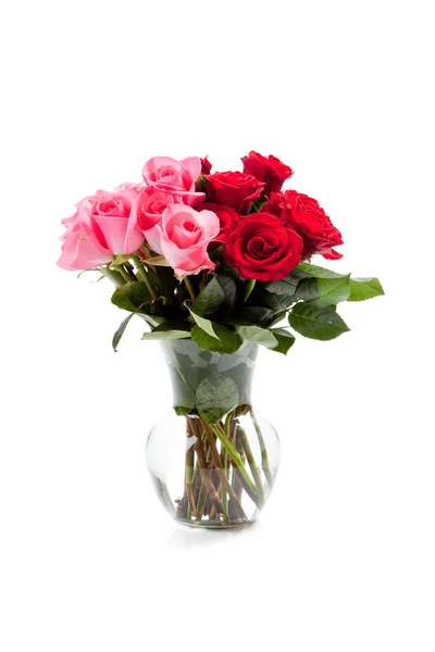 Rosas rosadas y rojas en un jarrón transparente sobre blanco — Foto de Stock
