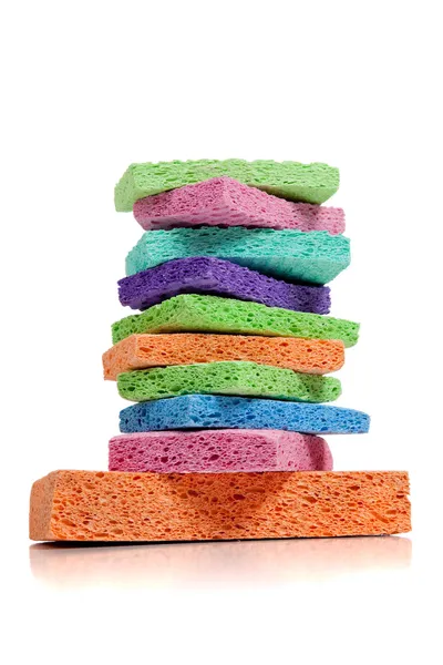 Stack of multi-colored sponges on white with copy space — Stock Photo, Image