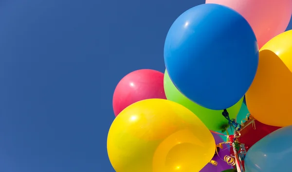 Multi colored balloons with a sky background — Stock Photo, Image