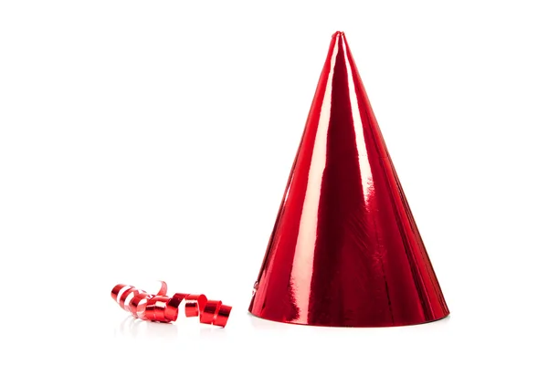 Un sombrero de fiesta rojo y serpentina en blanco —  Fotos de Stock