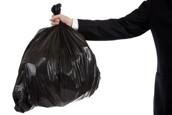 Business man's arm holding a bag of trash — Stock Photo, Image