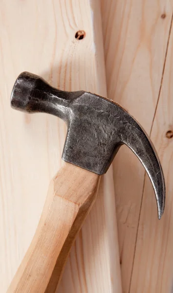 Hammer on a wood plank background — Stock Photo, Image