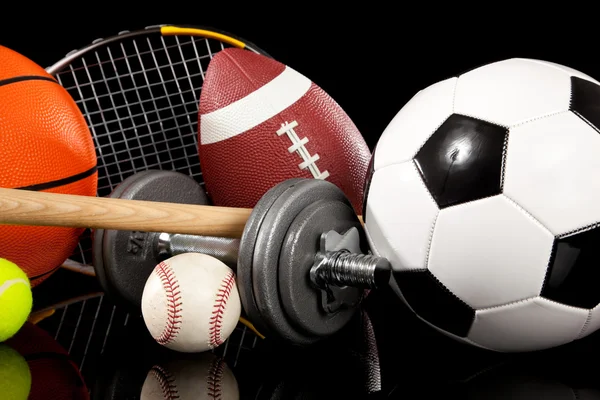 Assorted sports equipment on black — Stock Photo, Image