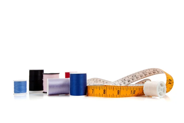 Tape measure and thread on white — Stock Photo, Image