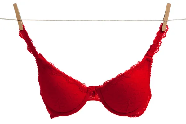 Red bra hanging on a clothes line with white — Stock Photo, Image