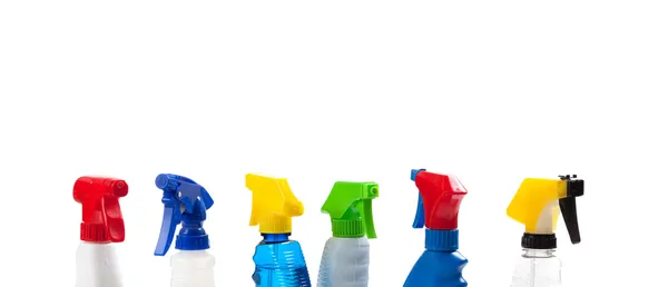 A row of assorted cleaning trigger bottles with copy space — Stock Photo, Image