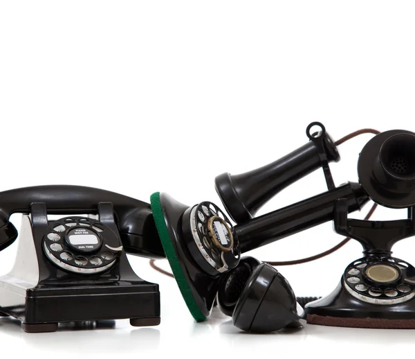 A group of vintage telephones on a white background — Stock Photo, Image