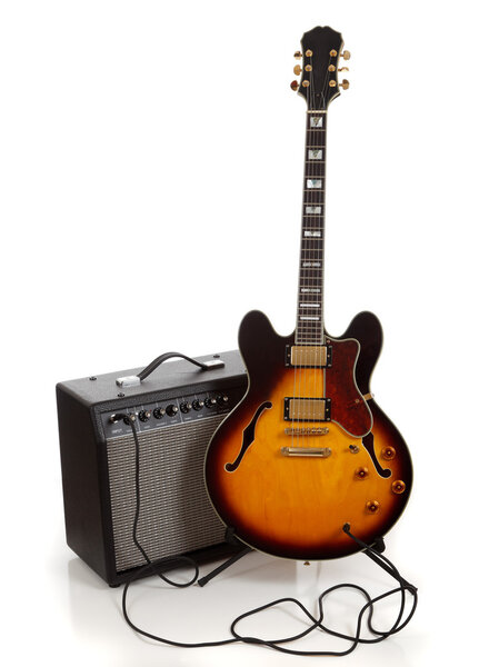 An electric guitar and amplifier on a white background