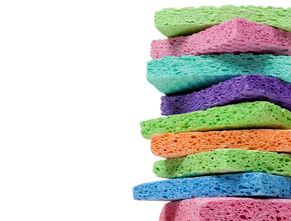 Montón de esponjas multicolores en blanco con espacio de copia —  Fotos de Stock