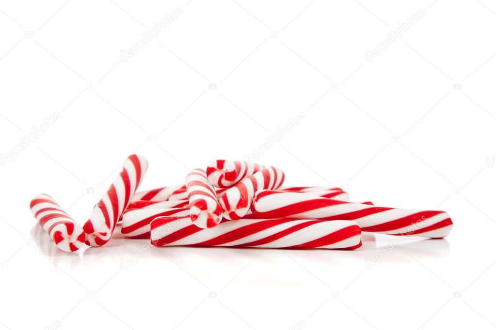 Red and white candy canes on white with copy space