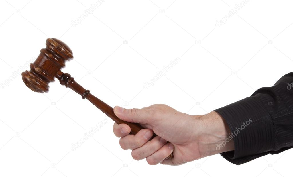 Hand holding a Brown gavel on a white background