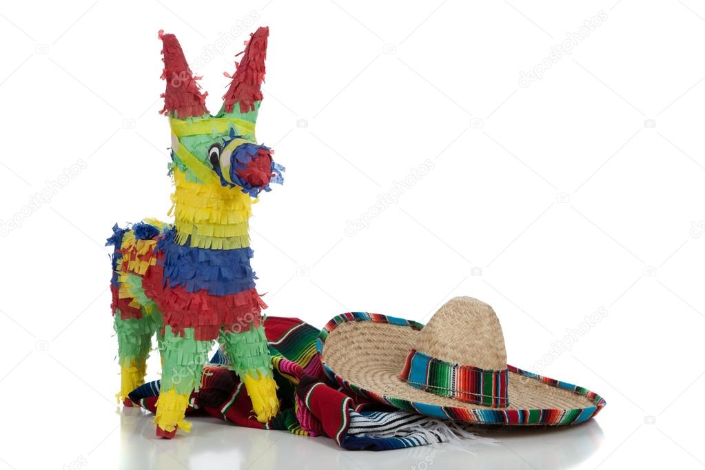 Serape, sombrero and pinata on a white background with copy space