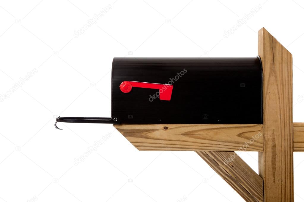 A black mailbox on a wooden post