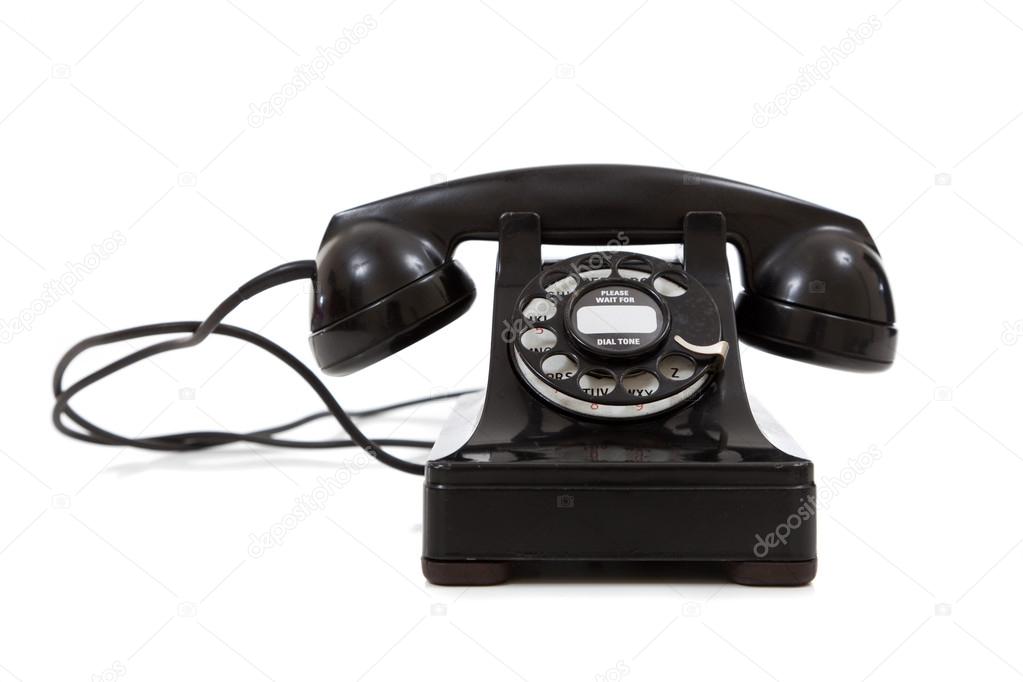 A vintage, black telephone on a white background