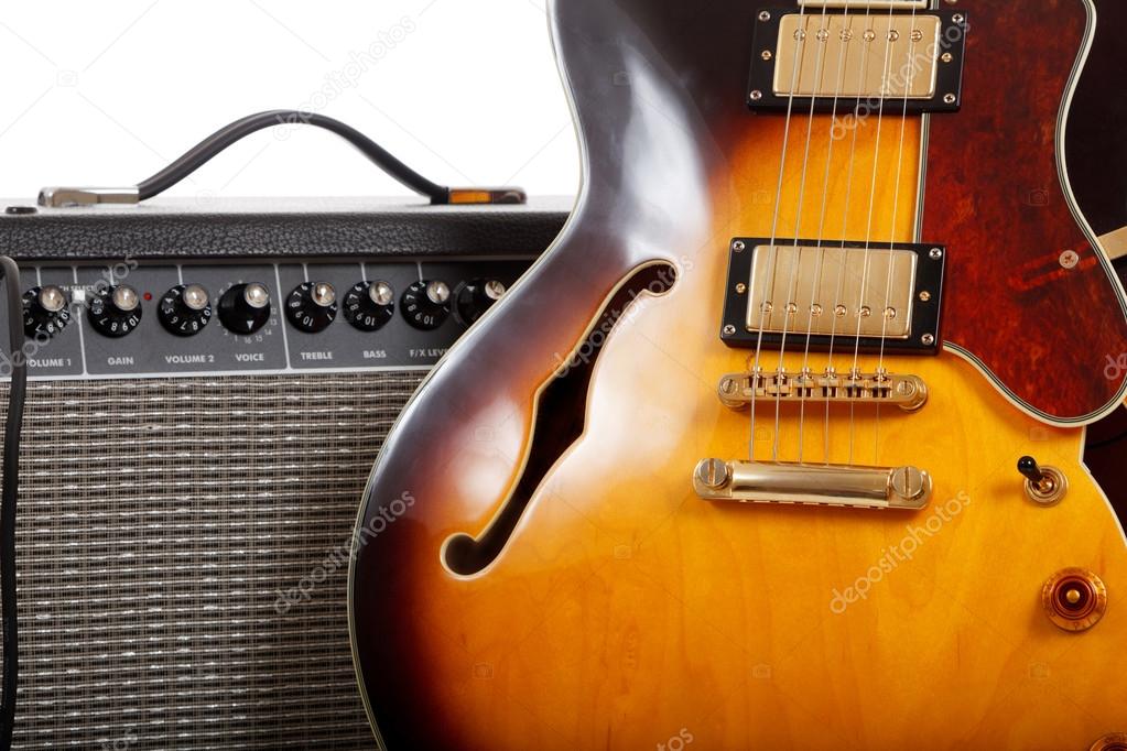 Electric guitar and amplifier on white background