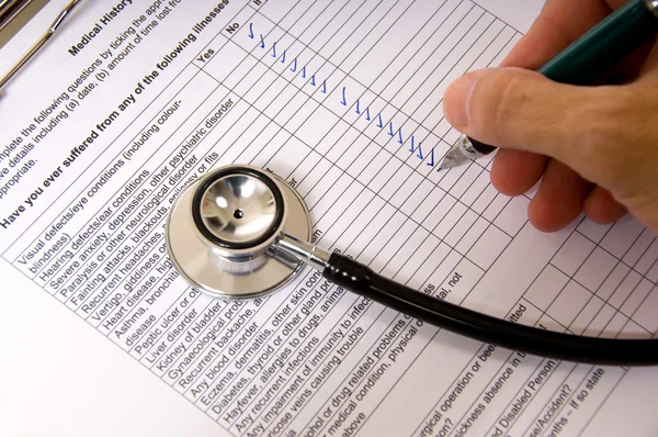 Um médico ou enfermeiro completando uma pergunta de paciente — Fotografia de Stock