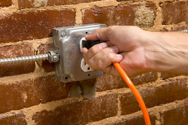 Plugging in an Extension cord — Stock Photo, Image