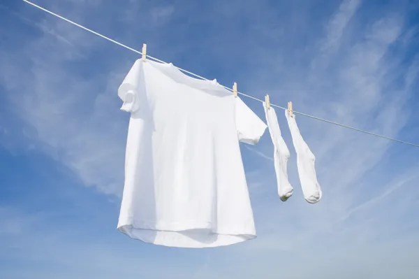 White T-Shirt and socks on Blue Sky — Stock Photo, Image