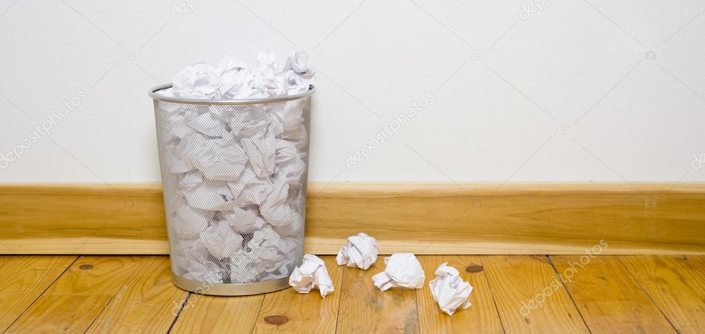 Office trash can on wood floor