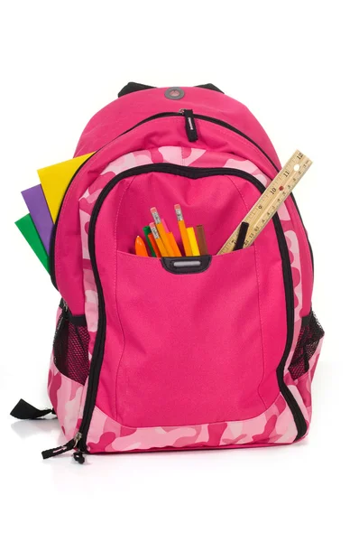 Roze packback met schoolbenodigdheden — Stockfoto