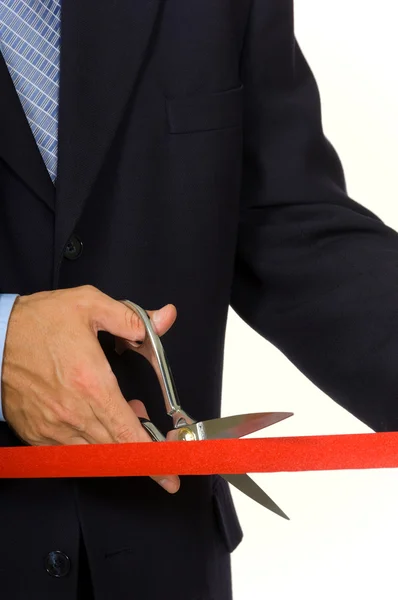 Man cutting red ribbon — Stock Photo, Image