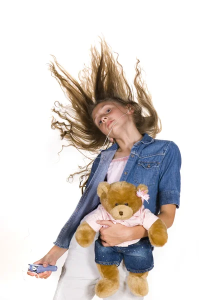 年轻女孩跳舞的泰迪熊和便携式音乐播放器 — 图库照片
