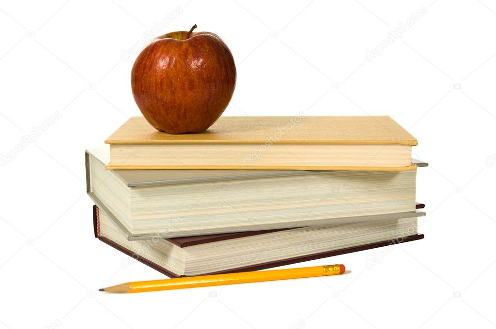 School books and apple against white