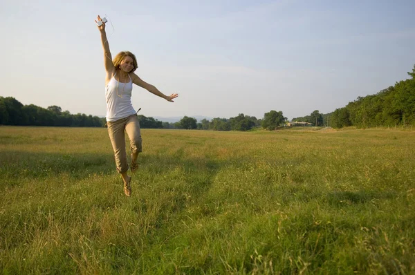 Pretty Teenage Girl listening to portable music player — Stock Photo, Image