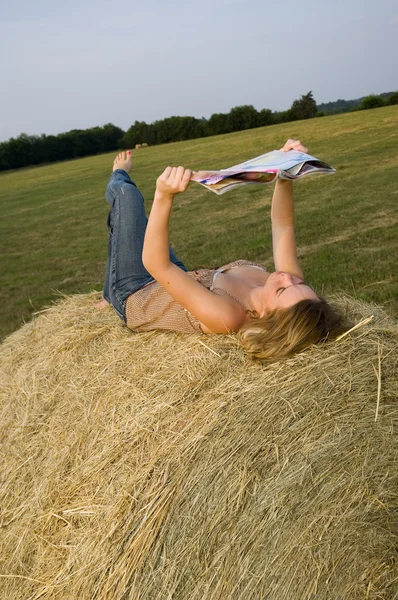 Mooi meisje tijdschrift lezen op boerderij — Stockfoto