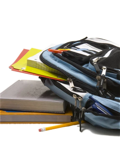 Blauer Schulrucksack voller Schulmaterial mit Schulbüchern — Stockfoto