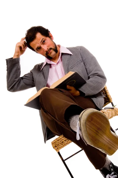 Bearded male student reading book - expressing confusion — Stock Photo, Image