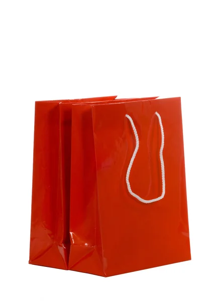 Czerwone torby na zakupy na biały — Zdjęcie stockowe