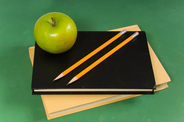 School books with green apple — Stock Photo, Image