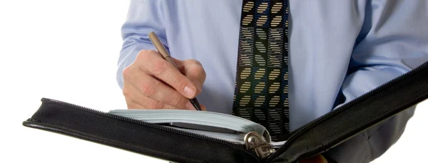 Hombre de negocios escribiendo en cuero organizador — Foto de Stock
