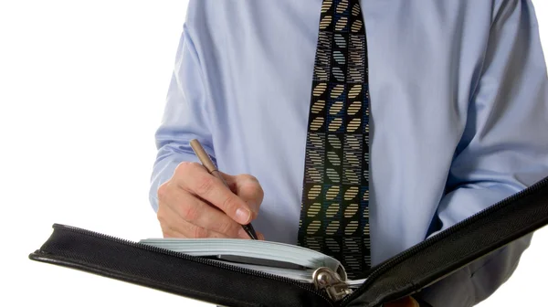 Zakenman schrijven in lederen organisator — Stockfoto