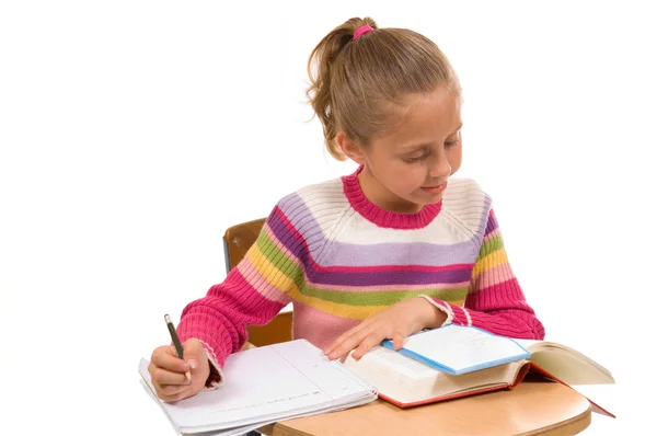 Young Girl at desk in school on white — Stock Photo, Image